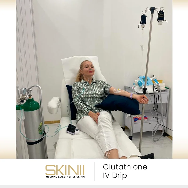 Woman relaxing in recliner while receiving glutathione IV drip therapy at Skin111 Medical & Aesthetics Clinic in Dubai.