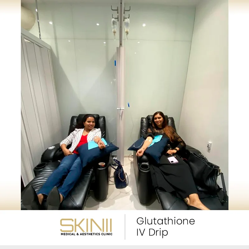 Women relaxing in recliners while receiving glutathione IV drip therapy at Skin111 Medical & Aesthetics Clinic in Dubai.
