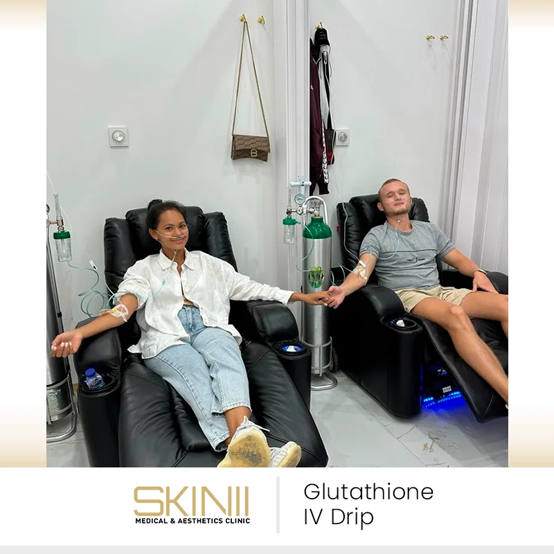 Couple relaxing in recliners while receiving glutathione IV drip therapy at Skin111 Medical & Aesthetics Clinic in Dubai.